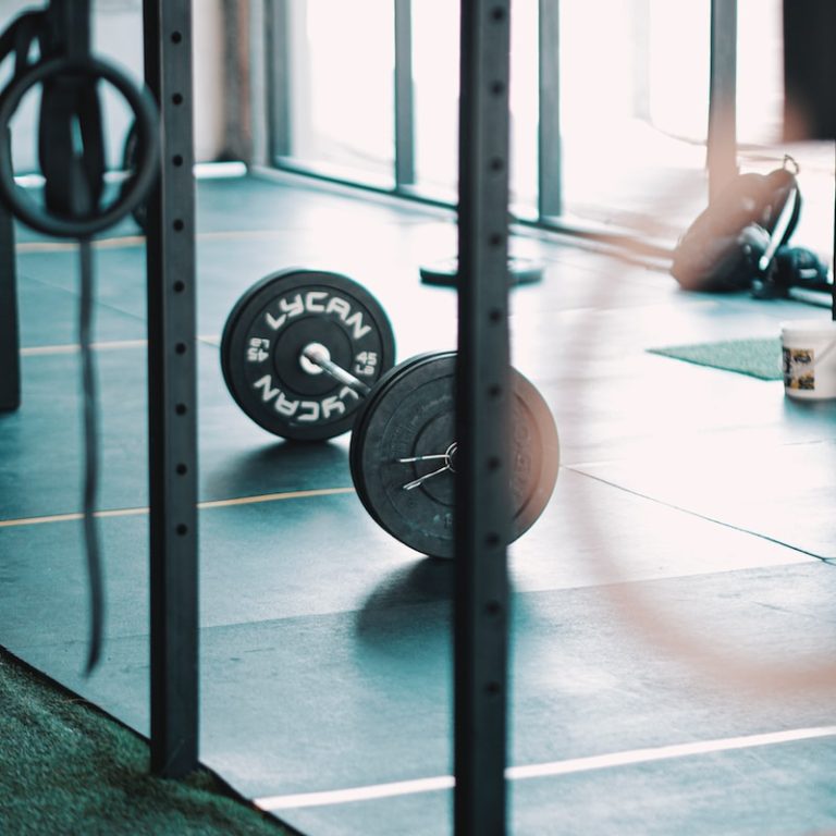 a gym with a barbell and weight plates